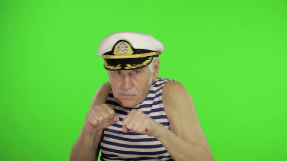 Elderly Sailor Man Is Angry and Shows a Fists. Sailorman on Chroma Key alt
