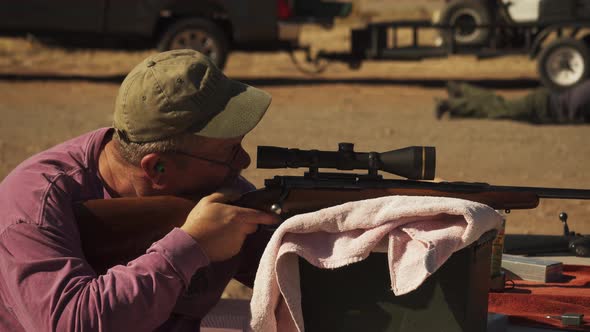 Target practice before deer season.  Serious attention is given to sighting the rifle.  Details make alt