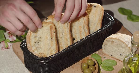 Put Fresh Toasters In A Wicker Basket On A Table Decorated With A Bouquet Of Flowers