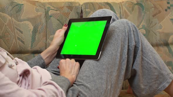 Adult Woman Holding Green Screen Tablet Computer