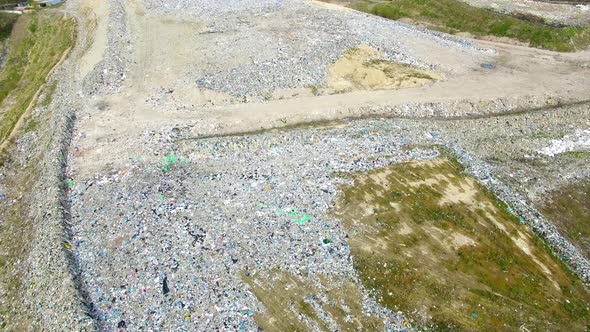 The huge garbage dump on the outskirts of the forest, view from drone alt