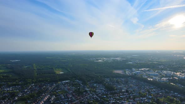 Slowly turning around a hot air balloon in the sky