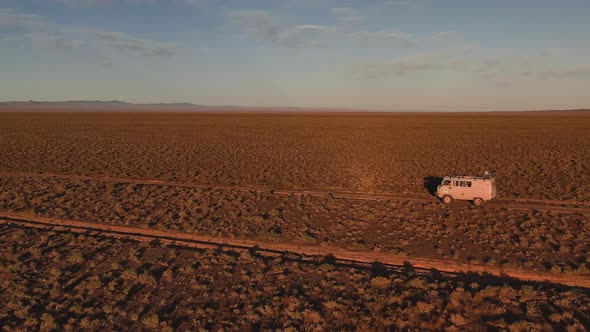 Aerial View Off Road 4X4 Car Driving Along Dirt Road Among the Desert alt