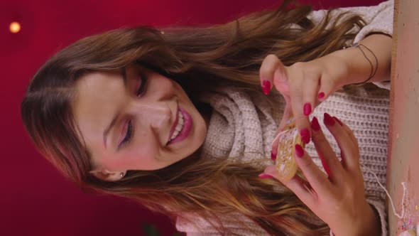 Vertical Shot Cute Smiling Brunette Young Woman Hung Christmas Gingerbread on Linen String