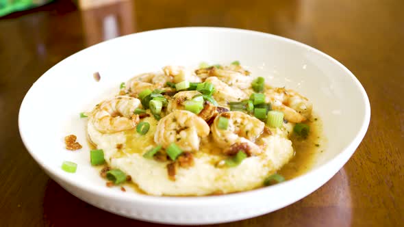 A plate of shrimp and grits steaming fresh and ready to eat alt