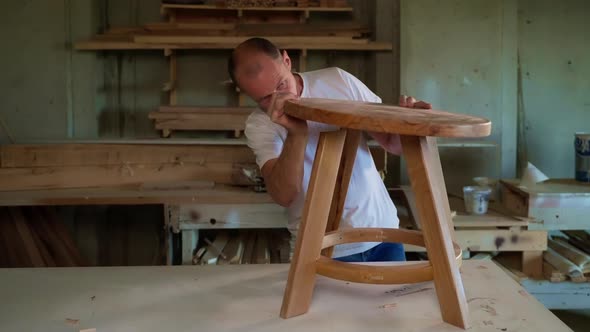 Joiner is Making Little Wooden Table in Workshop Installing Tabletop Hobby and Handmade alt