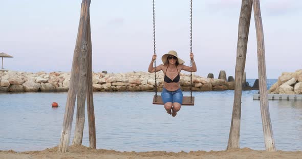 Tourist Relaxation on Swings alt
