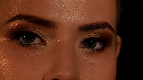 Beauty Eye with Makeup Blinking. Black. Closeup alt