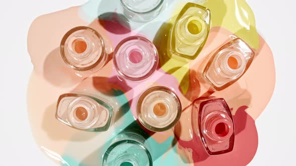 Multicolored Nail Polish Samples Spilled on White Background Isolated alt