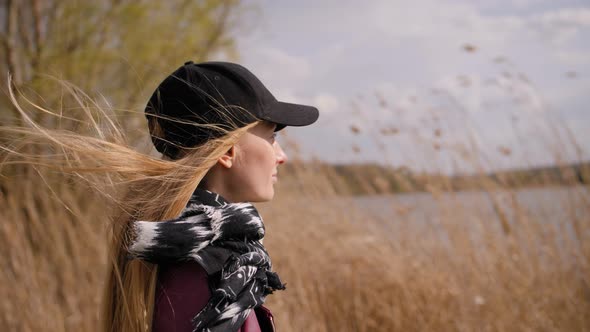 Portrait of Woman Standing on the Wind. SLOW MOTION . Windy Weather, Autumn or Spring. alt