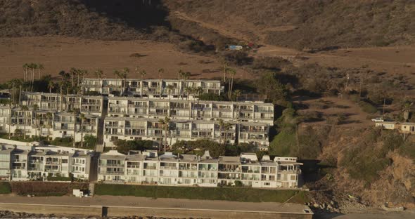 Helicopter aerial shot of small aircraft moving slowly closer to camera, foggy day alt