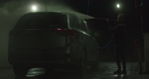 The Guy Is Washing the Car at the Selfservice Car Wash alt