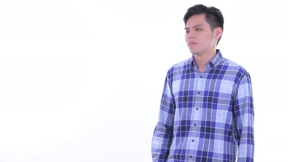 Stressed Young Asian Hipster Man Touching Something and Giving Thumbs Down alt