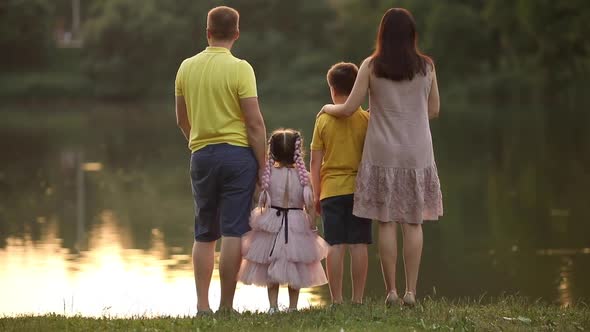 SLOW MOTION  Family Running on the Beach at Sunset with Happy Emotion