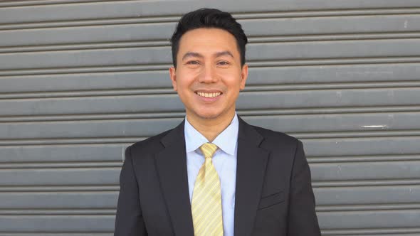Asian male businessman smile looking at camera