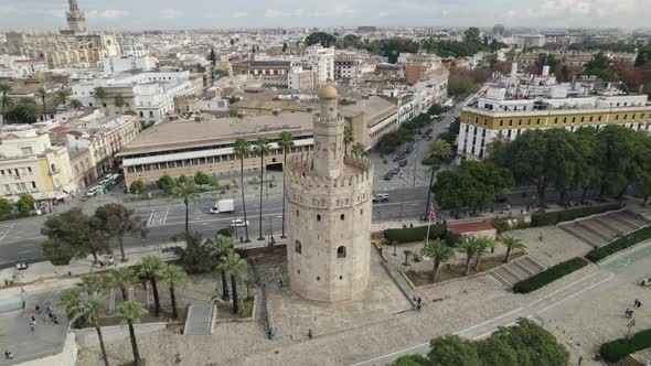 Aerial drone orbiting around Tower of Gold or Torre del Oro at Seville in Spain