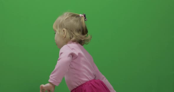 Happy Three Years Old Girl. Cute Blonde Child. Dancing and Make Faces alt