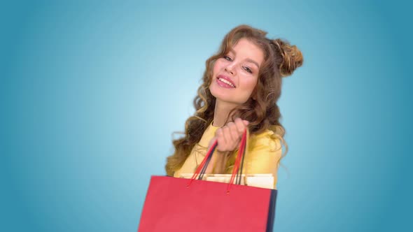 Beautiful Young Girl After Shopping Posing with Packages Spinning and Smiling While Looking Into the alt