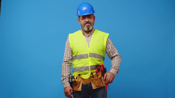 Senior Man Foreman Holding Tool Againast Blue Background
