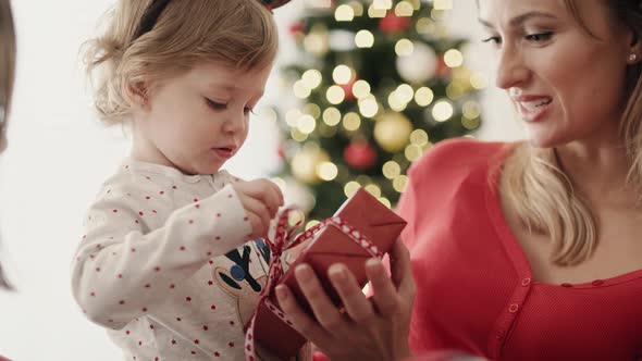 Video of little girl with Christmas present on Christmas morning alt