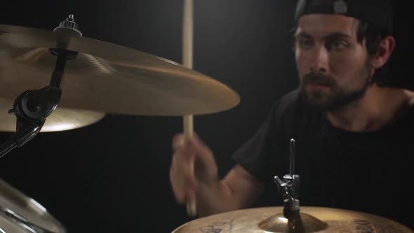 Musician Playing on Drum Kit Black Background Slow Motion alt