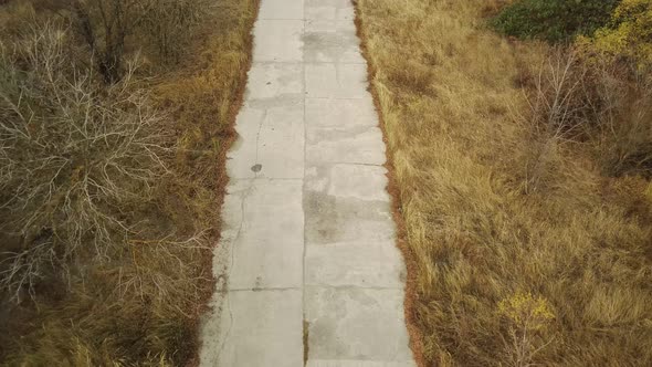 Aerial View of Old Destroyed Road in Countryside alt