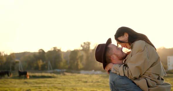 Romantic Couple Hugging in the Field at Sunset alt