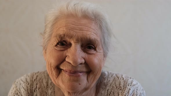 Close-up Portrait of an Elderly Happy Woman Smiling.