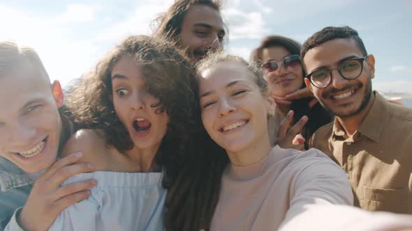 POV Portrait of Happy Young People Friends Taking Selfie Having Fun and Looking at Camera Outdoors alt