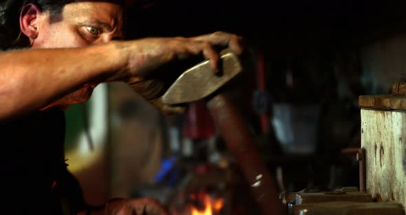 Blacksmith holding hammer alt