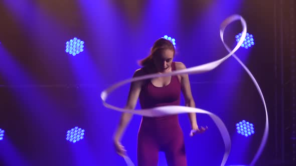 Rhythmic Gymnastics. Flexible Gymnast with Tape Creates Beautiful Hands Graceful Movements. Shot in alt