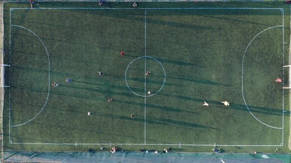 Aerial Shot Two Teams Playing Ball in Football Outdoors, Top View. Football Game Outdoors, Green alt