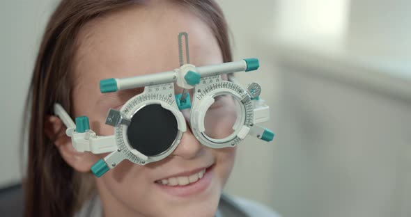 Schoolgirl Girl in a Bright Modern Optometrist's Office alt