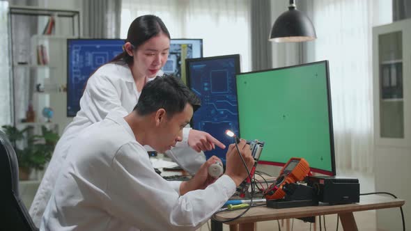 Engineer Project Manager Talks With Scientist Working On Green Chroma Key Screen Computer alt