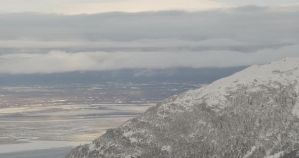 Aerial helicopter shot, US Army Blackhawk helicopter circles past camera and lands on tarmac, Drone 