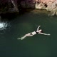 Girl Swimming Near Exotic Waterfall - VideoHive Item for Sale
