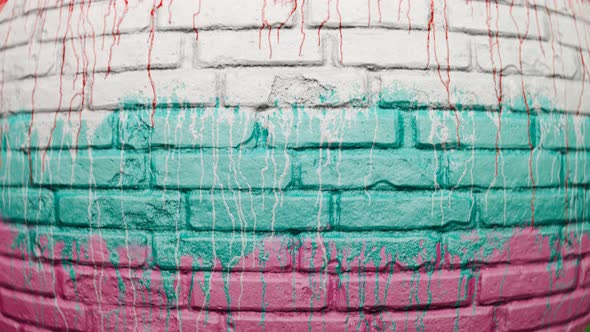 Colorful paint leaks on an old brick wall. Endless looping animation. 4KHD alt