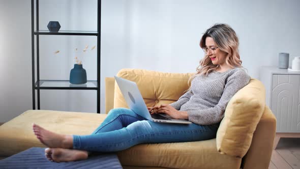 Happy Woman Relaxing on Couch Work Remote e Learning Use Laptop alt