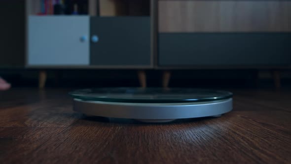 Person Male Measures the Body Weight Loss Standing on the Scale in the Living Room alt