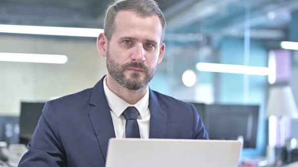 Portrait of Young Businessman Saying No with Finger Sign alt