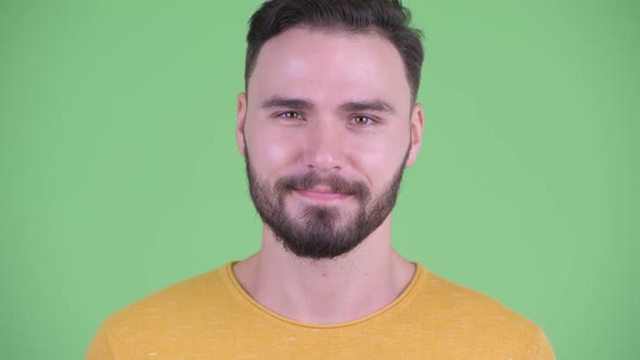 Face of Happy Young Handsome Bearded Man Nodding Head Yes alt