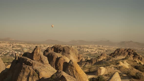 Woman Enjoying View of Hot Air Balloon Flying Over Cappadocia Valley