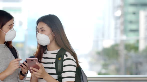 Asian teenager backpackers wearing protective PM 2.5 mask 