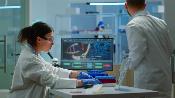 Team of Microbiology Scientists Discussing About Virus Development alt