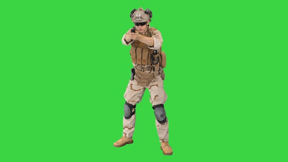 American Soldier with Pistol Aiming and Shooting on a Green Screen, Chroma Key. alt