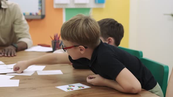 An African American Teacher Teaches a Group of Children Numbers Using Flashcards