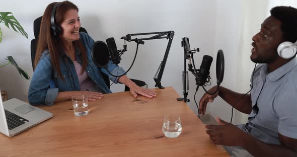 Hosts having podcast session together - Male speaker making an interview during live stream alt