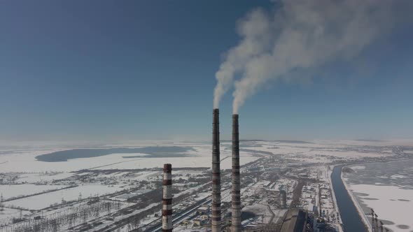 Thermal Power Plant  Smoking Chimneys Various Flights of Red and White Chimney in Winter Frosty Day