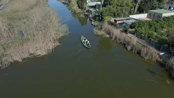 Aerial Drone Footage of a Boat with Tourists on It to Visit the Natural Park of the Albufera in alt