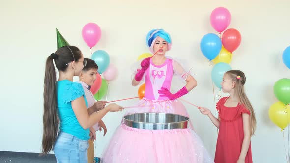 Kids with Lady in Fairy Suit Cook Cotton Candies at Birthday alt